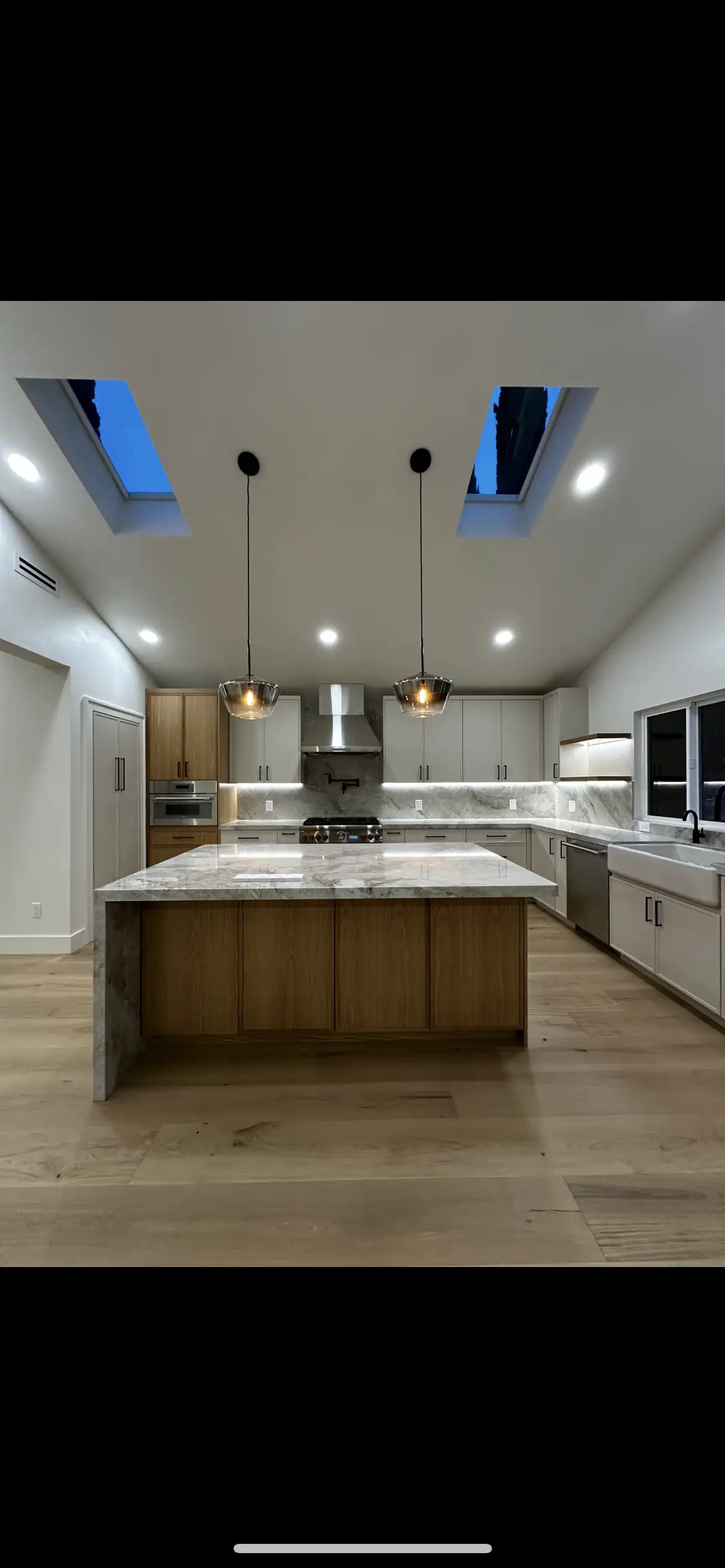 Kitchen remodel with skylights and stone island by Carrillo Construction & Remodeling